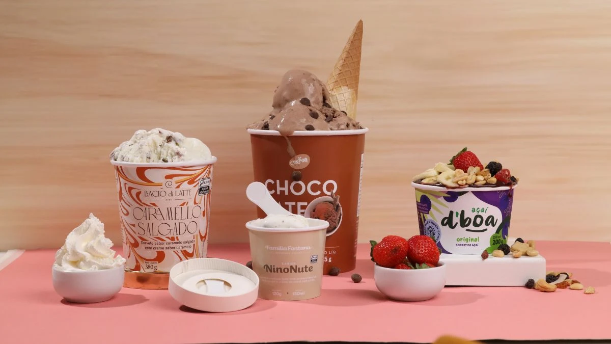 Variedade de embalagens e potes premium de sorvetes e iogurtes de diferentes sabores e cores, apresentando opções como sorvete de chocolate, de morango e iogurte com frutas.